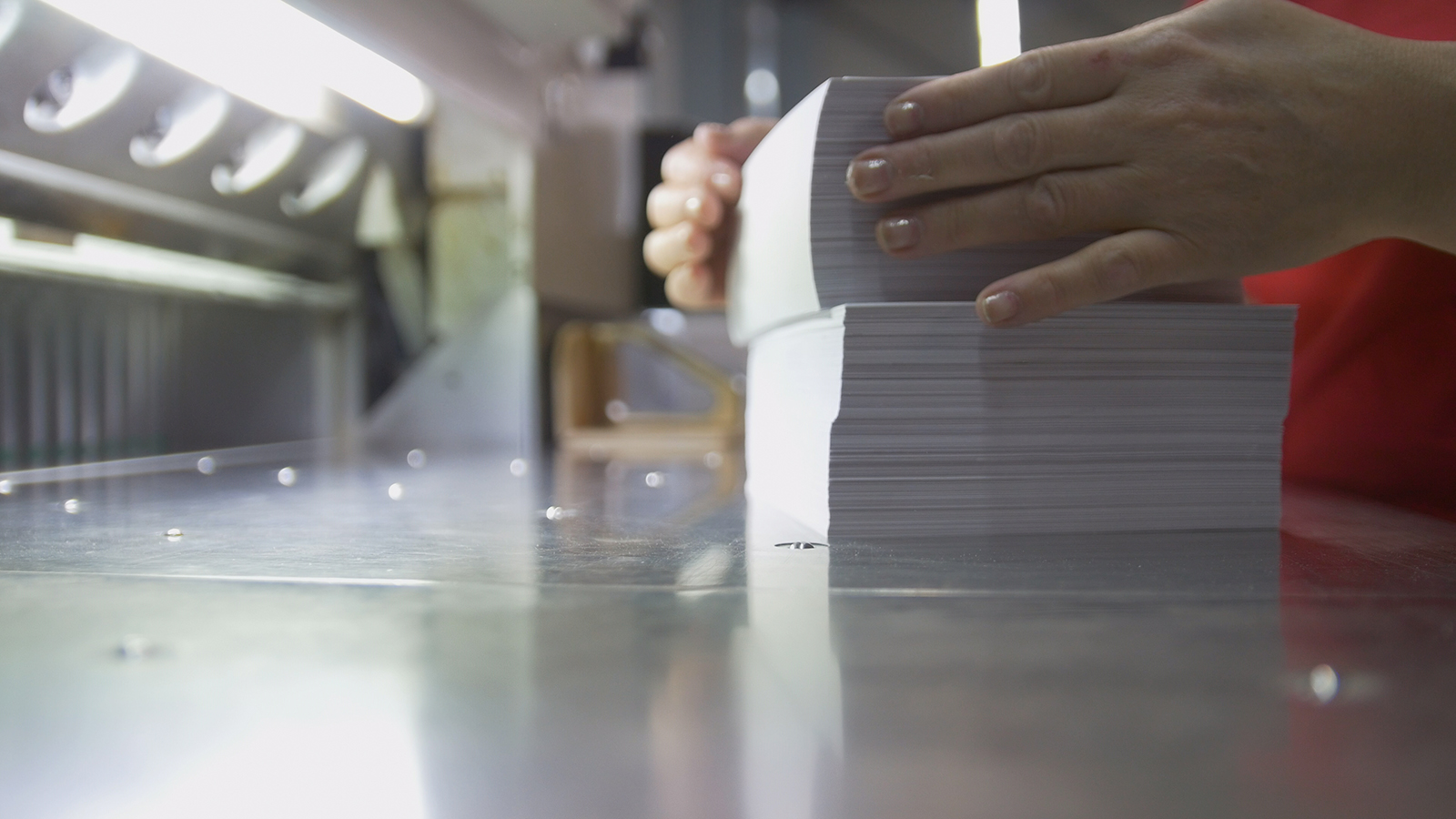 Typography - stack of paper near cutting machine, close up